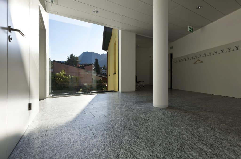 a finished building interior featuring a granite floor